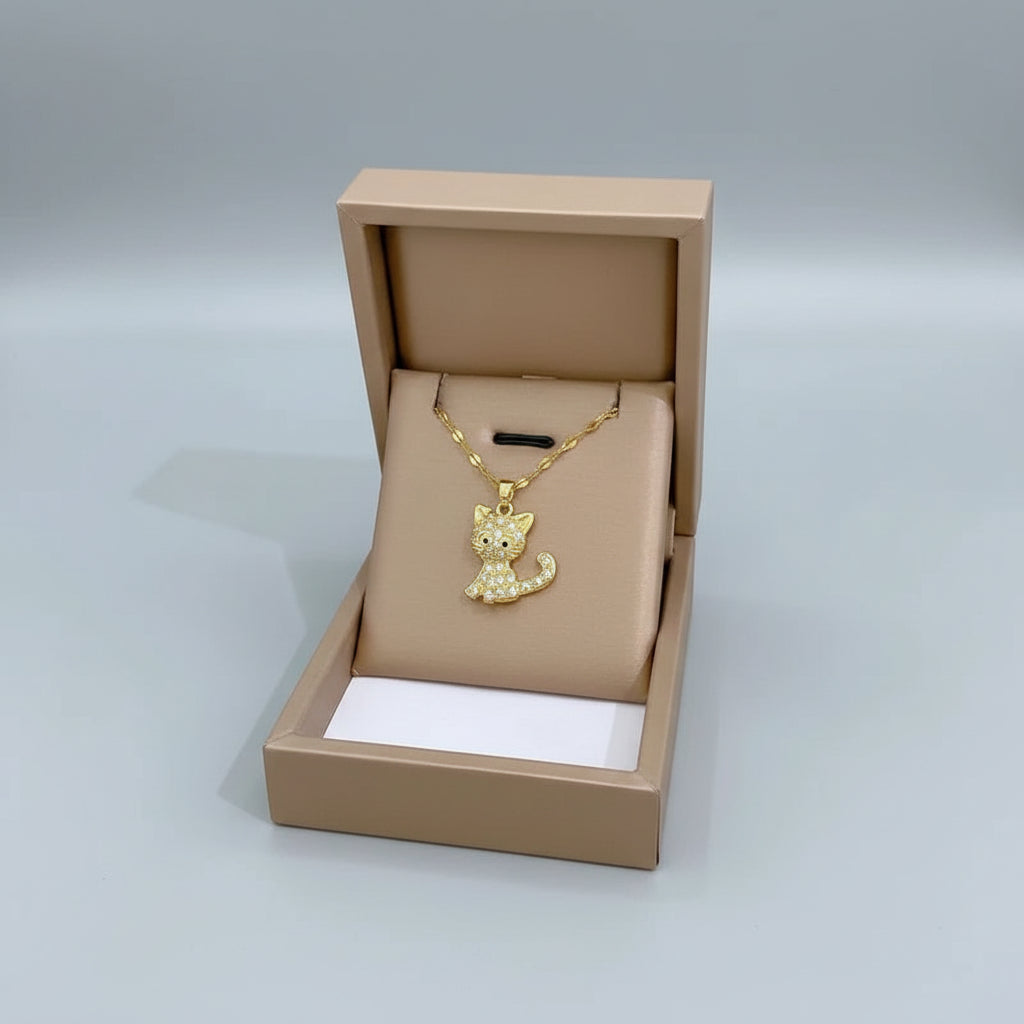 Gold cat-shaped pendant necklace in a beige jewelry box