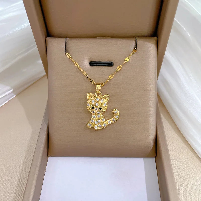 Gold cat-shaped pendant necklace in a beige jewelry box