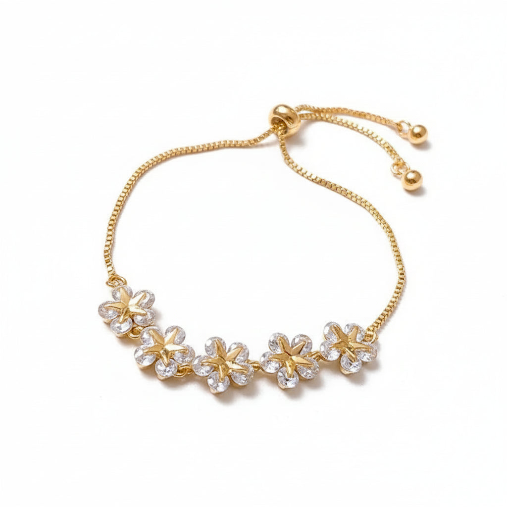 Gold bracelet with floral designs on a white background