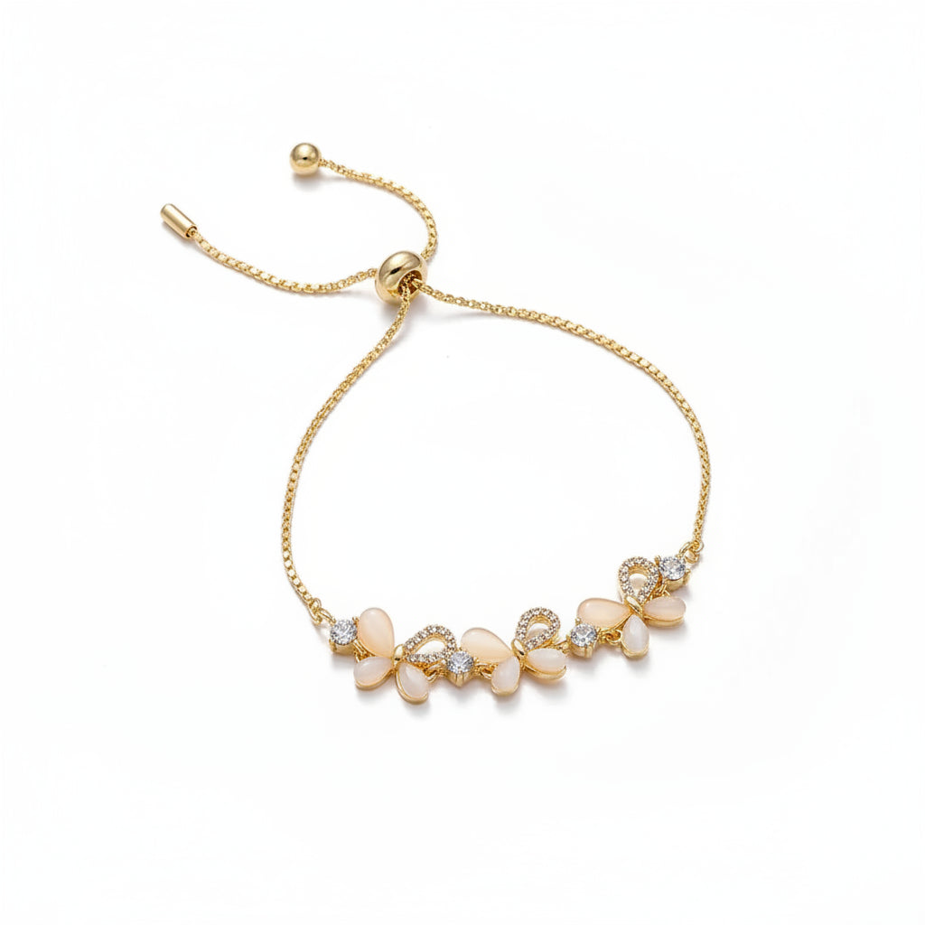 Gold bracelet with floral design on a beige fabric background