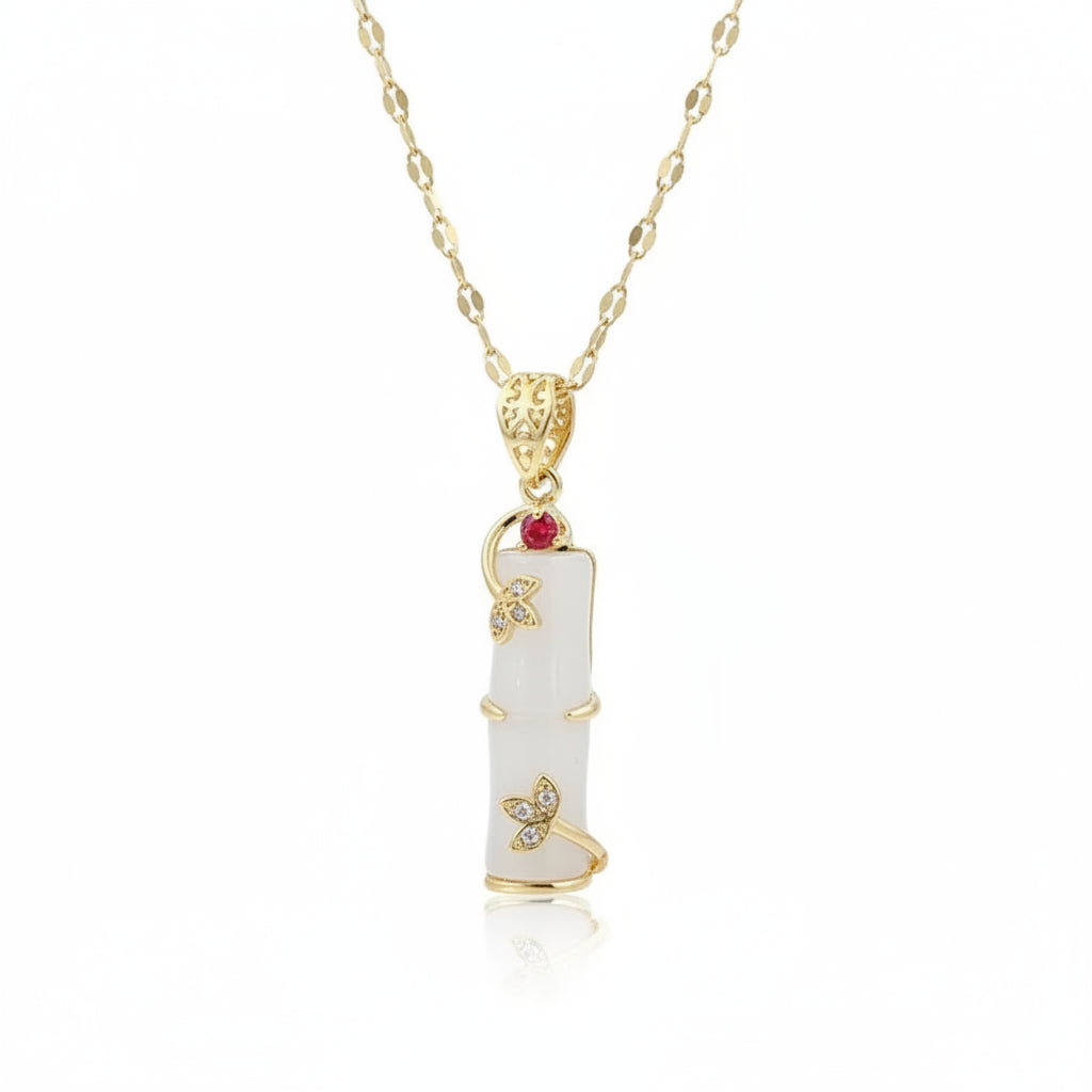 Necklace with a white pendant and gold accents on a blurred background